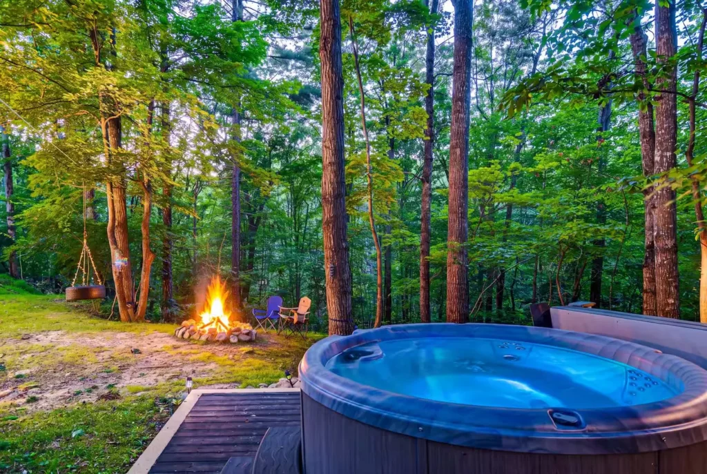 Hot tub and fire pit in the woods at a Luray, Virginia Airbnb rental
